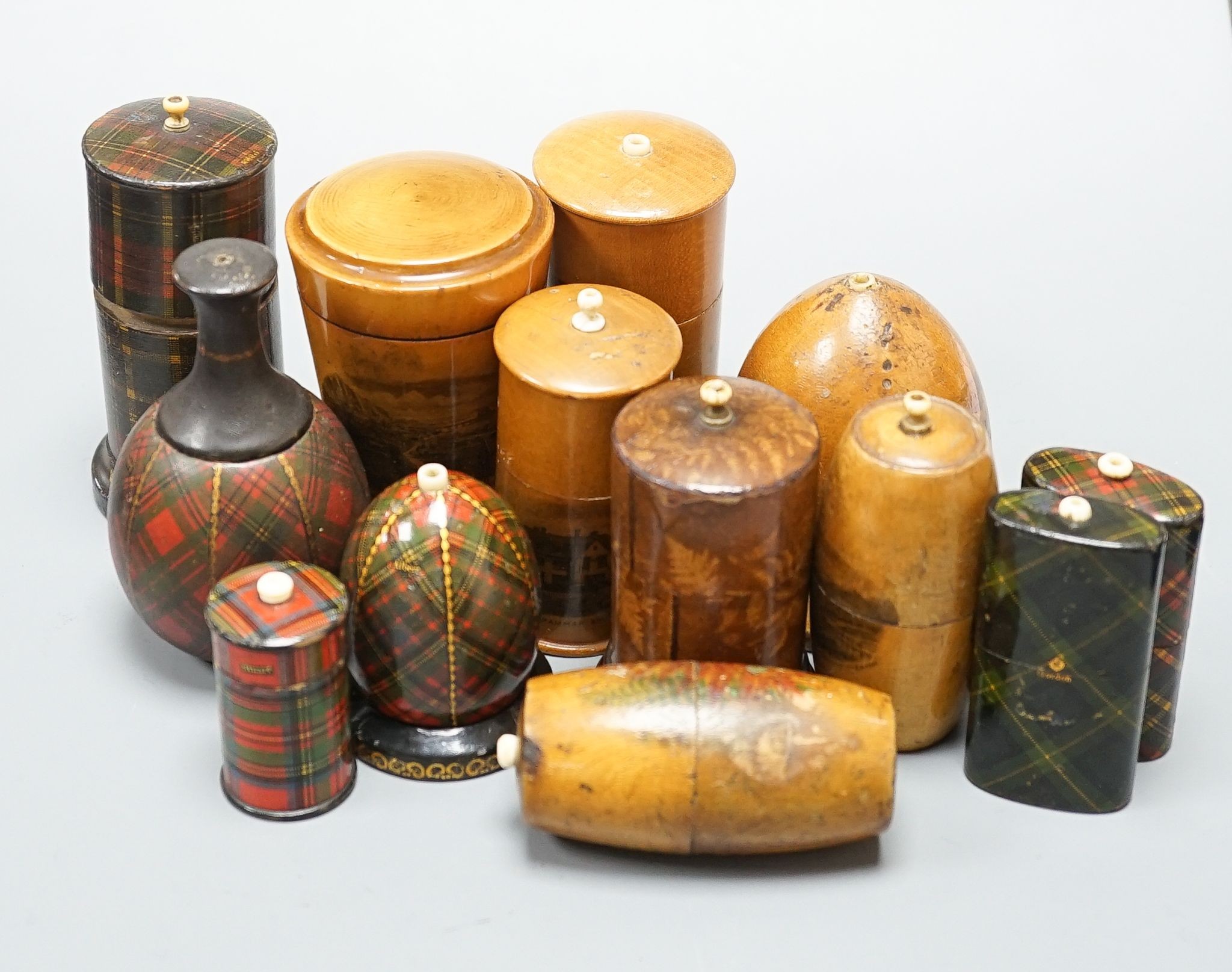 A group of tartanware, Mauchline and fern ware match holders with go-to-bed finials, and a similar tumbler case, tallest 9cm (13)